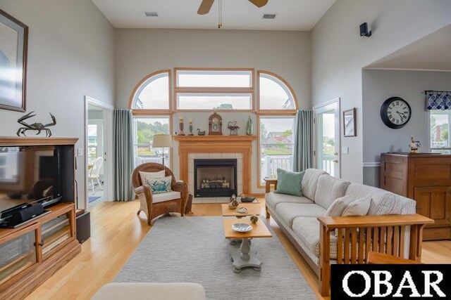 4025 Ivy Ln Lot 11, Kitty Hawk, NC 27949 - living area featuring light wood-style floors, a ceiling fan, a tile fireplace, and visible vents