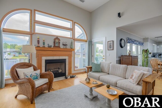4025 Ivy Ln Lot 11, Kitty Hawk, NC 27949 - living area with a towering ceiling, visible vents, wood finished floors, and a fireplace