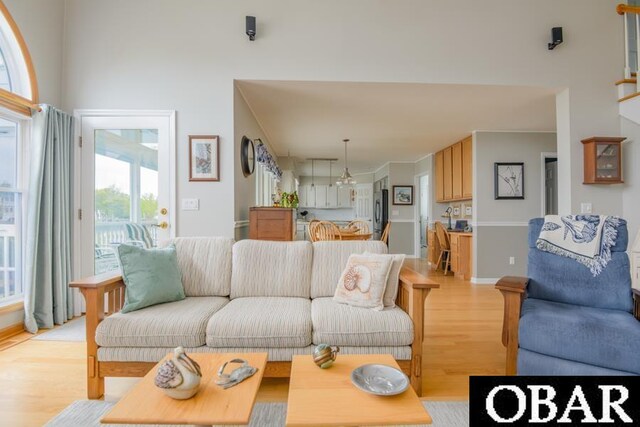 4025 Ivy Ln Lot 11, Kitty Hawk, NC 27949 - living room with light wood-type flooring, a high ceiling, and a wealth of natural light