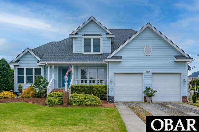4025 Ivy Ln Lot 11, Kitty Hawk, NC 27949 - view of front of property with covered porch, driveway, a front yard, a garage, and a shingled roof