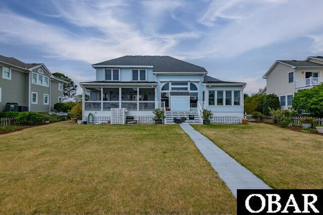 4025 Ivy Ln Lot 11, Kitty Hawk, NC 27949 - exterior space with a lawn, fence, a shingled roof, and a sunroom