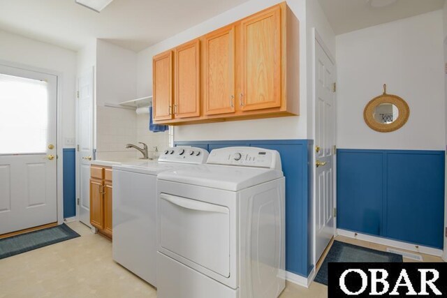 4025 Ivy Ln Lot 11, Kitty Hawk, NC 27949 - laundry area featuring independent washer and dryer, cabinet space, wainscoting, a sink, and a decorative wall