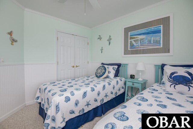 4025 Ivy Ln Lot 11, Kitty Hawk, NC 27949 - carpeted bedroom featuring a closet, crown molding, a wainscoted wall, and ceiling fan