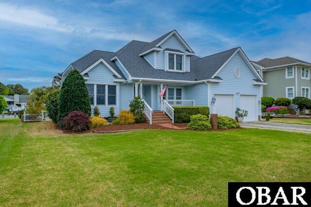 4025 Ivy Ln Lot 11, Kitty Hawk, NC 27949 - view of front facade with a porch, a garage, concrete driveway, and a front lawn