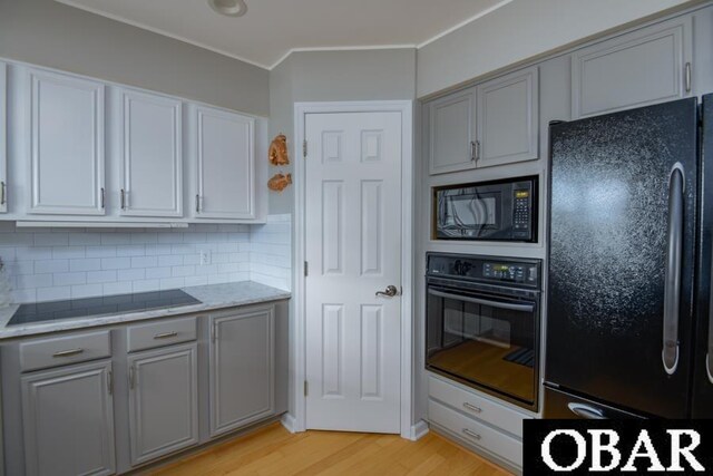 4025 Ivy Ln Lot 11, Kitty Hawk, NC 27949 - kitchen with ornamental molding, tasteful backsplash, light wood finished floors, black appliances, and gray cabinetry