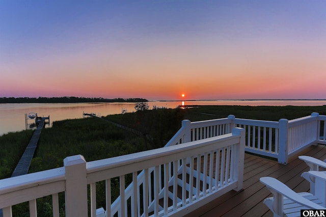 wooden terrace featuring a water view