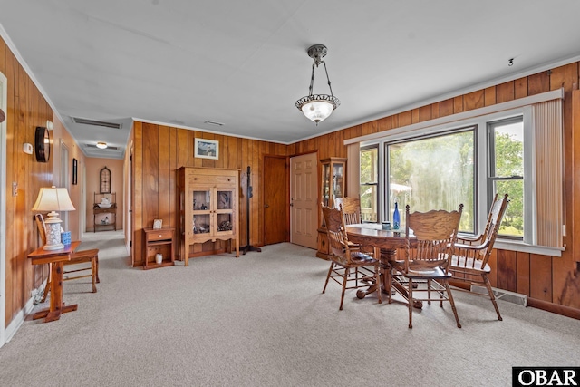 57194 M V Australia Ln, Hatteras, NC 27943 - carpeted dining space with wood walls, plenty of natural light, baseboards, and crown molding