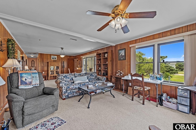 57194 M V Australia Ln, Hatteras, NC 27943 - carpeted living room featuring wooden walls, a ceiling fan, crown molding, and beamed ceiling