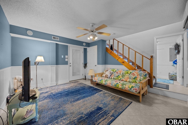 305 W Fourth St Lot 7, Kill Devil Hills, NC 27948 - tiled living area featuring a wainscoted wall, a textured ceiling, a ceiling fan, and stairway
