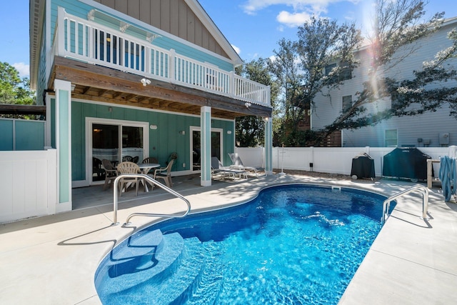 view of pool featuring a patio area, fence, a deck, and a fenced in pool