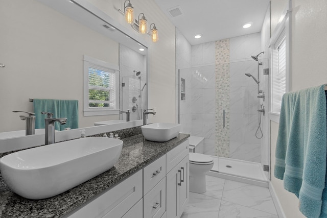 full bathroom featuring marble finish floor, a stall shower, a sink, and visible vents