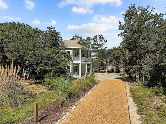 view of front of home featuring driveway and a balcony