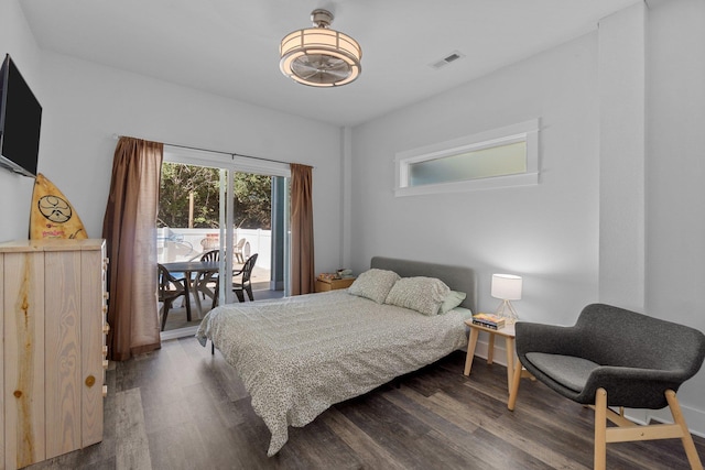 bedroom with access to outside, visible vents, and wood finished floors