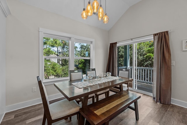 dining room featuring a chandelier, wood finished floors, lofted ceiling, and baseboards