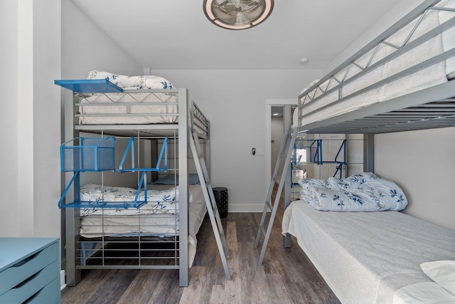 bedroom with wood finished floors and baseboards