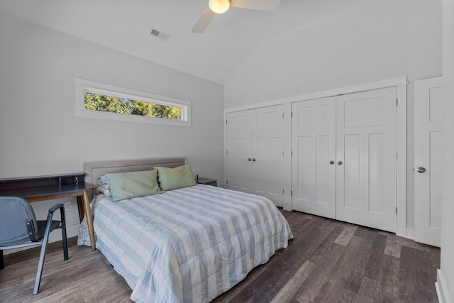 bedroom with wood finished floors, visible vents, a ceiling fan, vaulted ceiling, and a closet