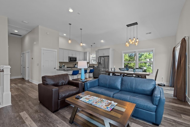 living room featuring dark wood-style floors, visible vents, high vaulted ceiling, and recessed lighting