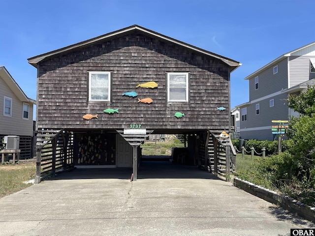 3737 Hallett St Lot # 100, Kitty Hawk, NC 27949 - coastal inspired home featuring a carport and concrete driveway