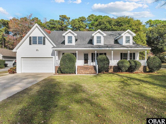 cape cod home with driveway, a shingled roof, an attached garage, covered porch, and a front yard