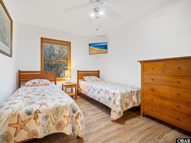 bedroom with light wood-type flooring and a ceiling fan