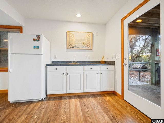 2203 Pike Rd Lot 37, Corolla, NC 27927 - kitchen featuring freestanding refrigerator, white cabinets, dark countertops, light wood-type flooring, and recessed lighting