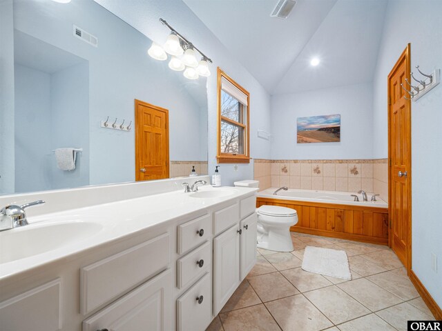 2203 Pike Rd Lot 37, Corolla, NC 27927 - bathroom featuring lofted ceiling, toilet, a bath, tile patterned floors, and double vanity