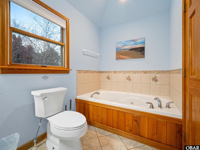 full bathroom with vaulted ceiling, a garden tub, toilet, and tile patterned floors