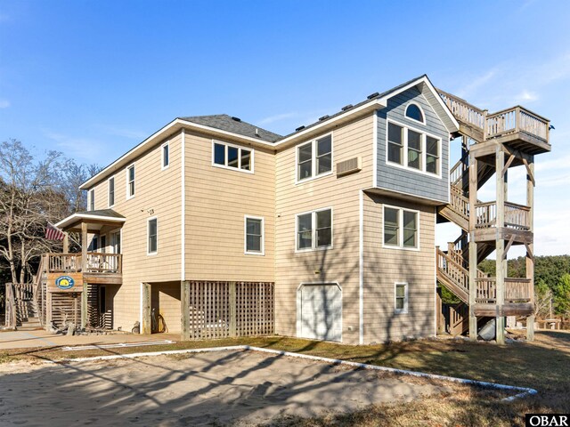 2203 Pike Rd Lot 37, Corolla, NC 27927 - view of home's exterior featuring stairway, an attached garage, and a wooden deck