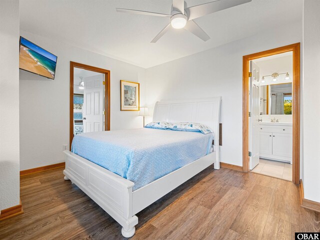 2203 Pike Rd Lot 37, Corolla, NC 27927 - bedroom featuring wood finished floors, baseboards, ensuite bath, and ceiling fan