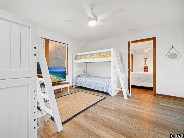 bedroom featuring baseboards, ceiling fan, and light wood-style floors