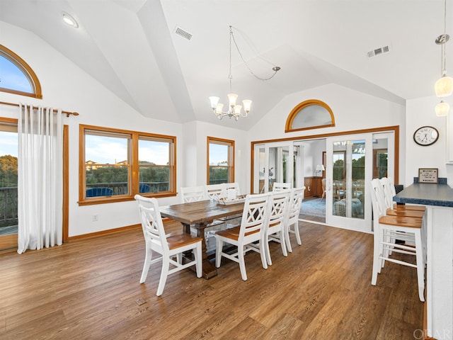 dining room with visible vents, vaulted ceiling, and dark wood-type flooring