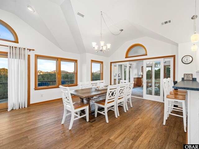 2203 Pike Rd Lot 37, Corolla, NC 27927 - dining space featuring wood finished floors, a chandelier, baseboards, and high vaulted ceiling