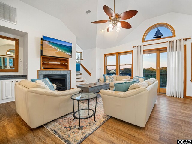 2203 Pike Rd Lot 37, Corolla, NC 27927 - living area featuring wood finished floors, ceiling fan, a tile fireplace, and high vaulted ceiling