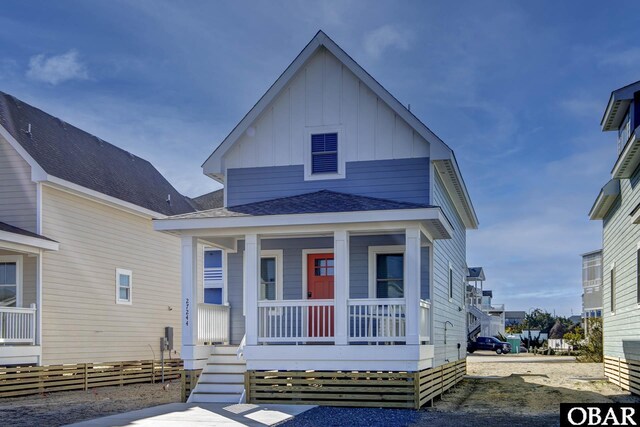 27250 Sand St Lot # 7, Salvo, NC 27972 - view of front of home featuring board and batten siding, covered porch, and a shingled roof