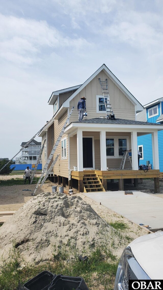 27250 Sand St Lot # 7, Salvo, NC 27972 - view of front of home with board and batten siding, a porch, and a shingled roof