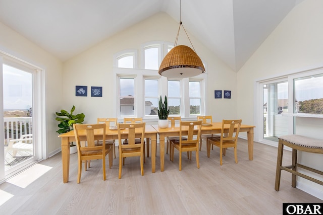 25245 Island Pines Dr Lot 6, Waves, NC 27982 - dining area with light wood-type flooring, a healthy amount of sunlight, and high vaulted ceiling