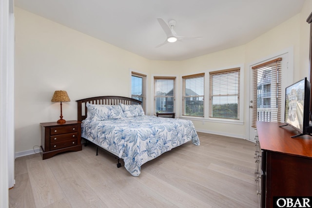 25245 Island Pines Dr Lot 6, Waves, NC 27982 - bedroom featuring baseboards, multiple windows, and light wood-style floors