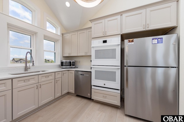 25245 Island Pines Dr Lot 6, Waves, NC 27982 - kitchen with a sink, stainless steel appliances, light countertops, light wood-style floors, and vaulted ceiling