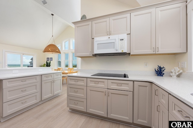 25245 Island Pines Dr Lot 6, Waves, NC 27982 - kitchen with lofted ceiling, black electric stovetop, white microwave, pendant lighting, and light wood-style floors