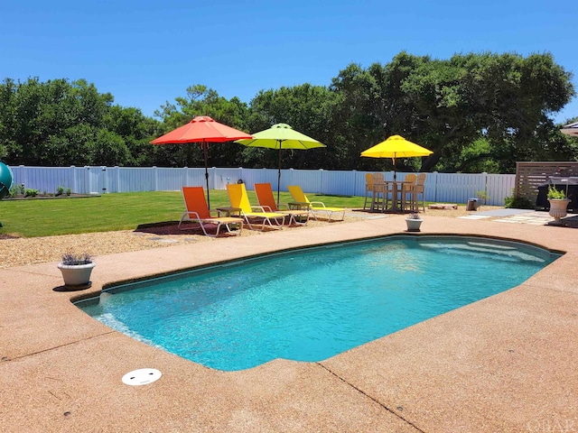 view of pool featuring a yard, a patio area, a fenced backyard, and a fenced in pool