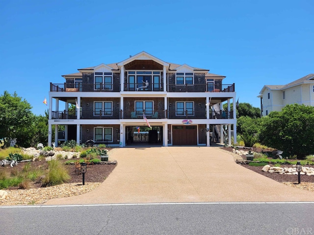 view of front facade with a carport, concrete driveway, and a garage