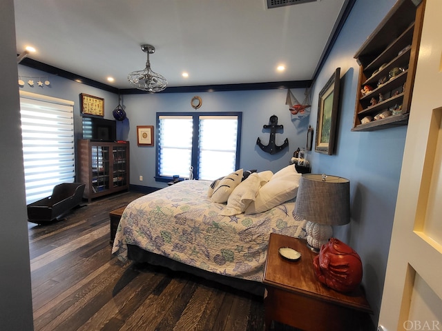 bedroom featuring baseboards, dark wood-style flooring, visible vents, and crown molding