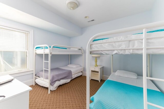 bedroom featuring carpet, visible vents, and baseboards