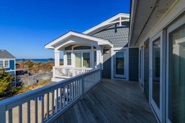 wooden terrace featuring a water view