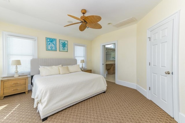 bedroom with light colored carpet, visible vents, baseboards, and multiple windows