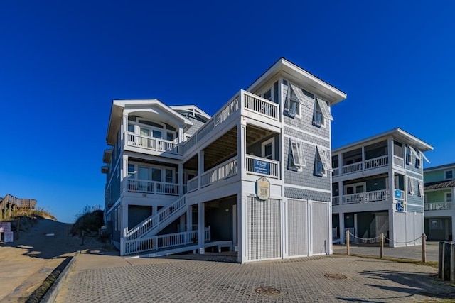 back of property with a balcony and driveway