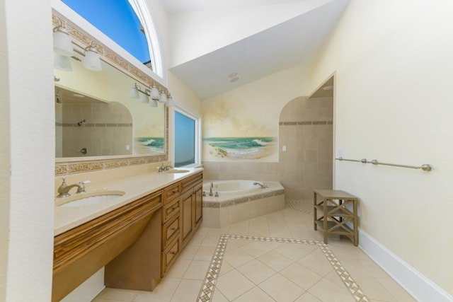 full bathroom featuring a garden tub, baseboards, a sink, and tile patterned floors