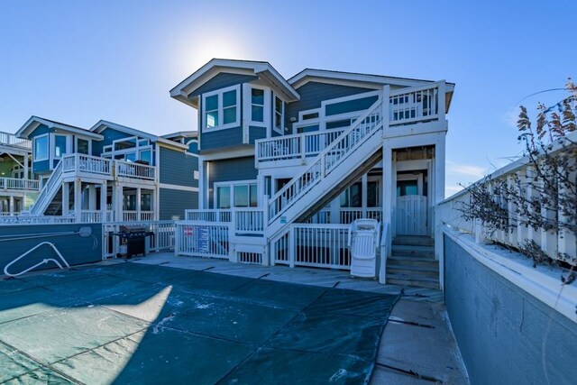 back of house featuring stairs and fence