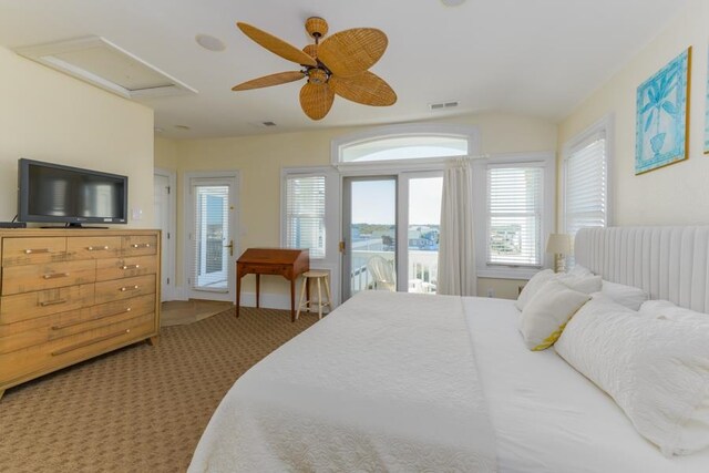 carpeted bedroom with lofted ceiling, access to exterior, visible vents, and a ceiling fan