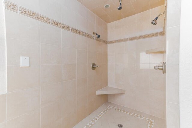 bathroom with tiled shower